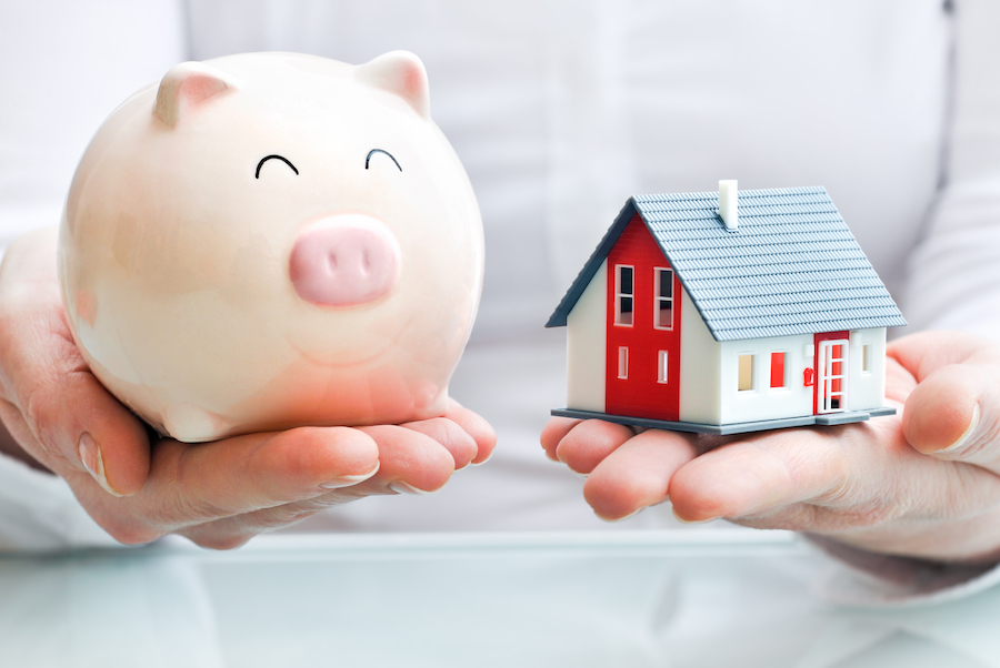 Hands holding a piggy bank and home indicating a mortgage tradelines for sale.